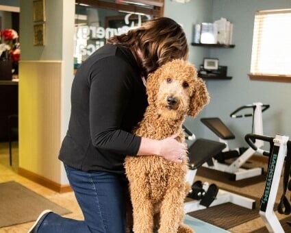 Dr Marcy providing Chiropractic care to a dog at the marysville clinic